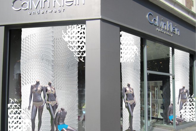 The vertically hung Honeycomb in the Calvin Klein display case 